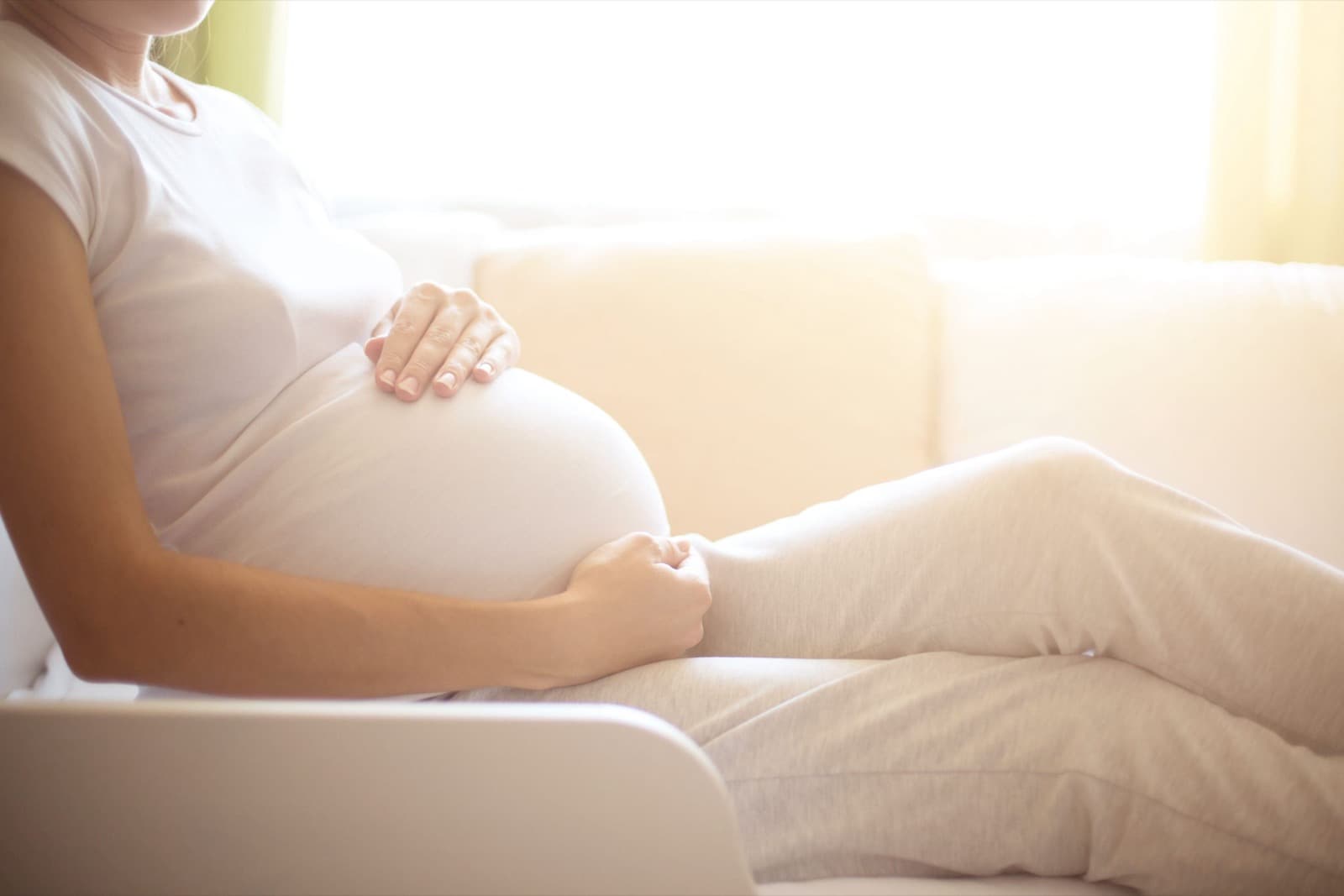 Pregnant woman cradling her belly — obstetrics and pregnancy care in Libertyville